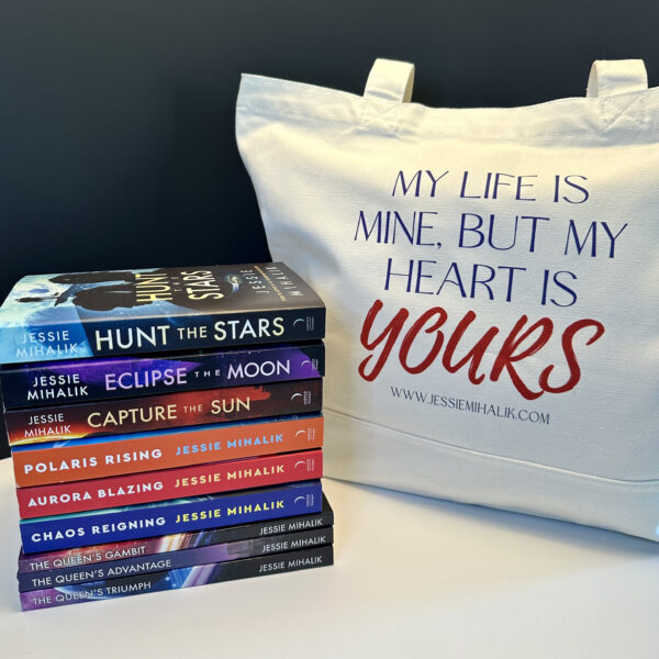 A stack of nine books next to a tote with "My life is mine but my heart is YOURS" on it.