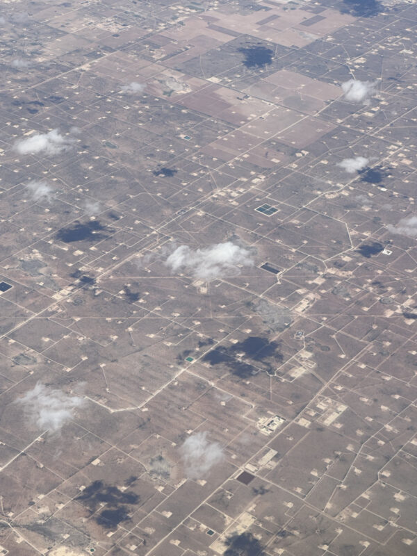 A brown landscape dotted with lighter roads and squares, like a circuit board.